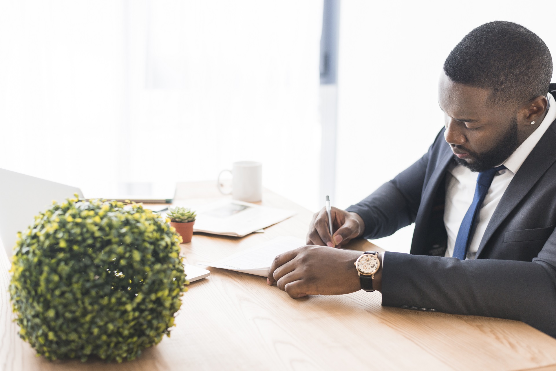 businessman-sitting-writing-table