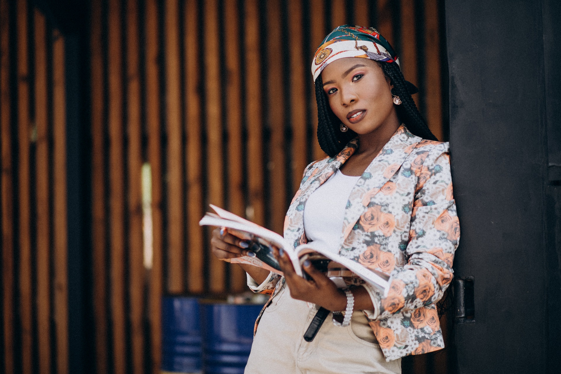 Stylish african american reading magazine in the street