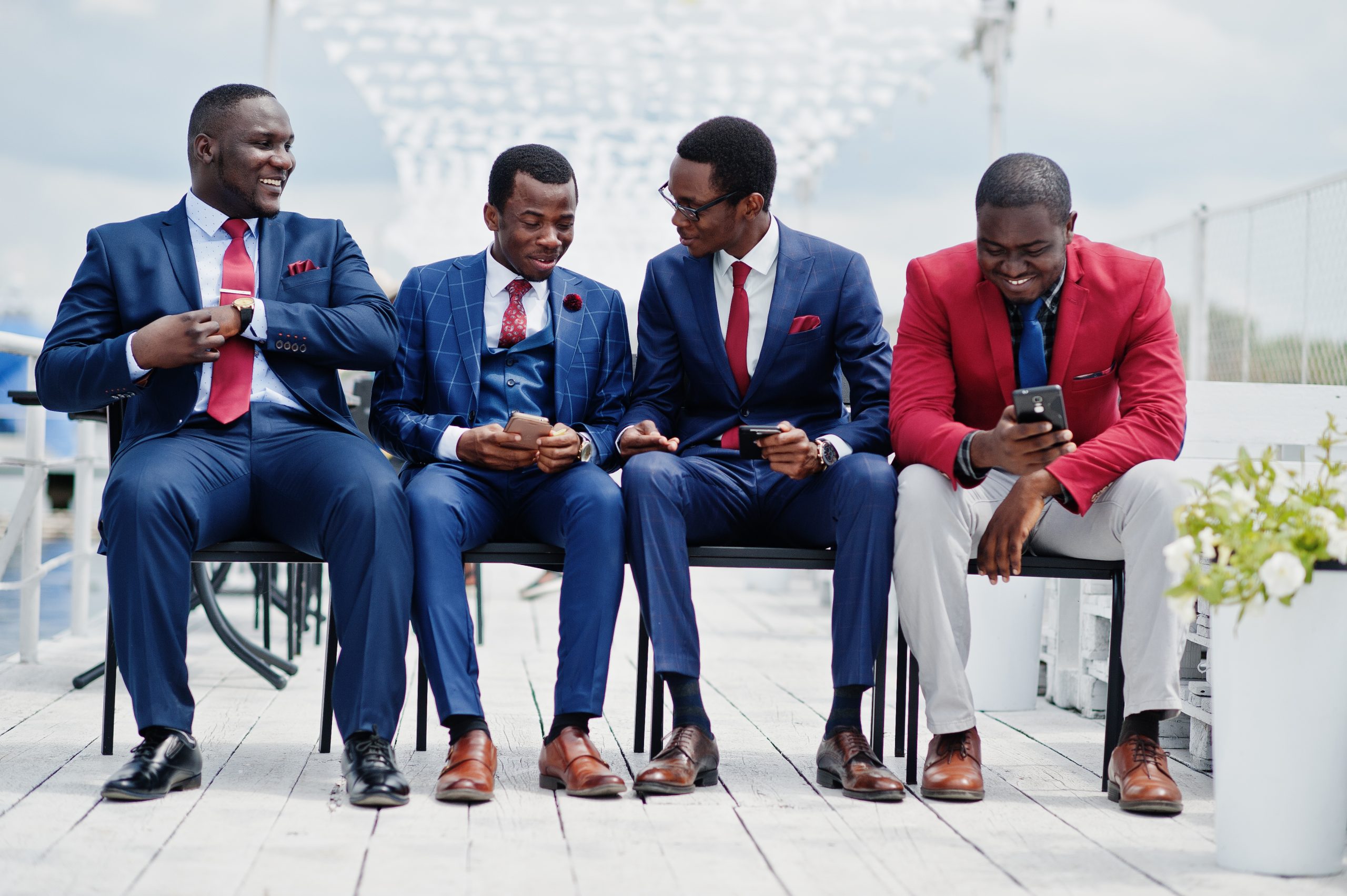 Group of four african american happy succesfull mans at suit. Ri